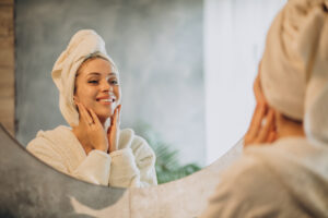 woman home applying cream mask